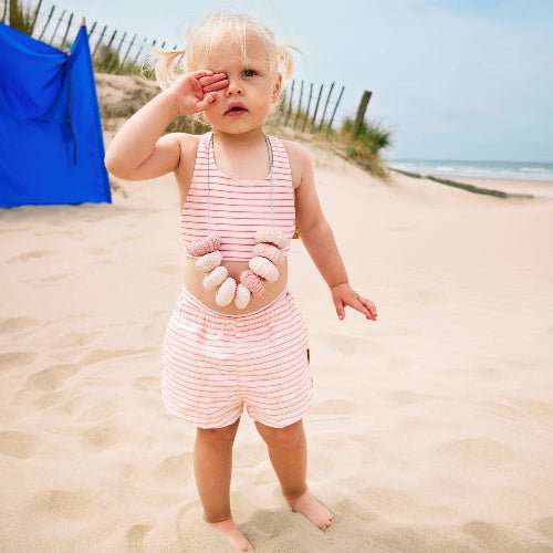 Baby Girl wearing matching striped cream and peach bikini top and swim shorts