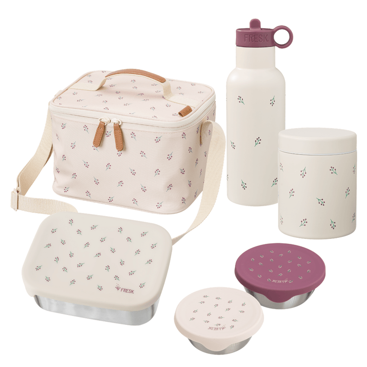 A coordinated lunch bag set with matching containers on a white background. The set includes a soft-sided lunch bag with a shoulder strap, a reusable bottle with a purple lid and handle, a cylindrical container with a white lid, a rectangular bento-style container with a patterned lid, a small round container with a patterned lid, and two purple lids.