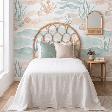 Bedroom with ocean-themed wallpaper, bed, and side table.