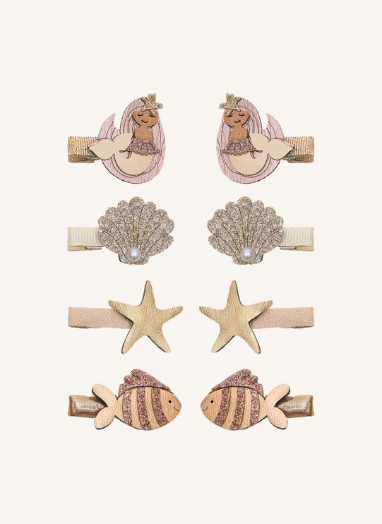 Six mermaid-themed hair clips. The clips include two mermaid designs with pink and beige tones, two shell clips with rhinestone detailing and pearl accents, two starfish clips