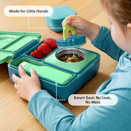 Child with a green and blue bento box 