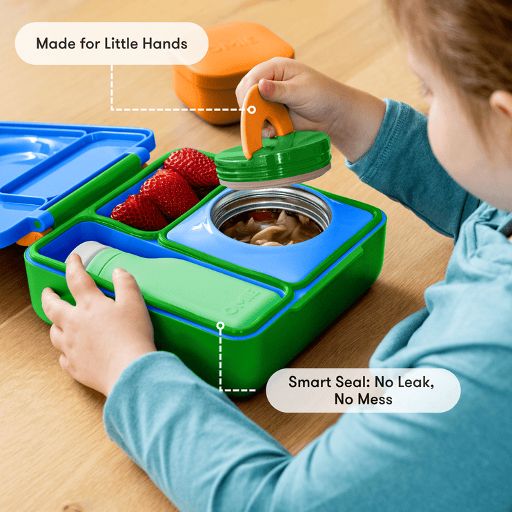 Child interacting with a colorful bento box 