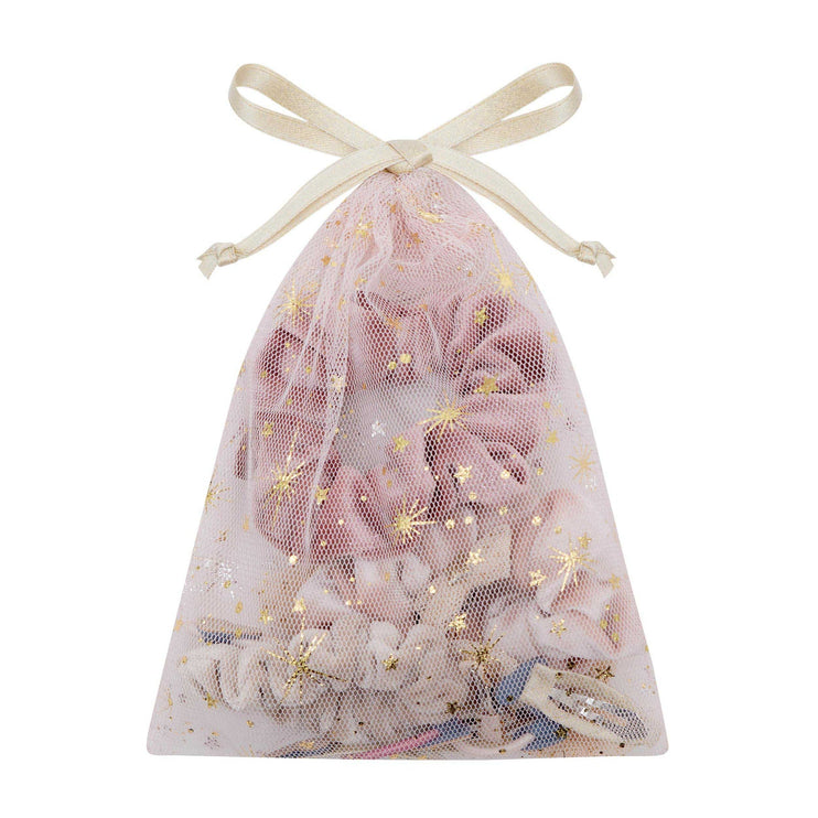 A pink tulle drawstring bag filled with pink scrunchies and decorated with gold star and sparkle prints, tied with a cream ribbon