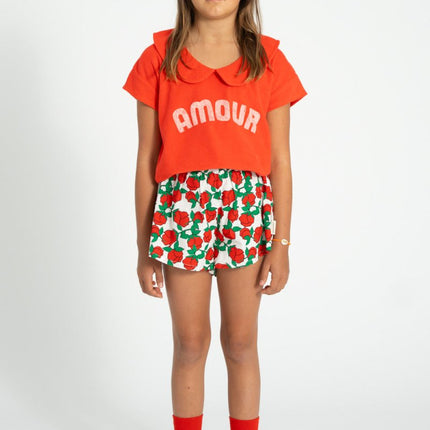 kid wearing red tshirt with peter pan collar pair with red roses printed short