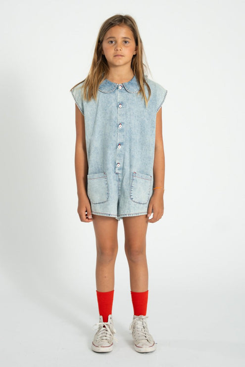 girl wearing light blue denim jumpsuit 