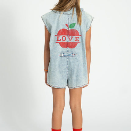 girl wearing denim jumpsuit with apple and love design on the back