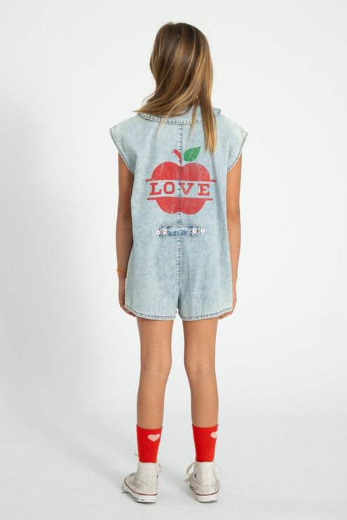 girl wearing denim jumpsuit with apple and love design on the back