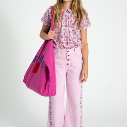 a girl wearing a pink pants with floral print side