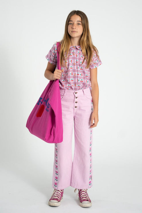 a girl wearing a pink pants with floral print side