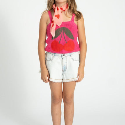 girl wearing pink knitted top pair with denim shorts
