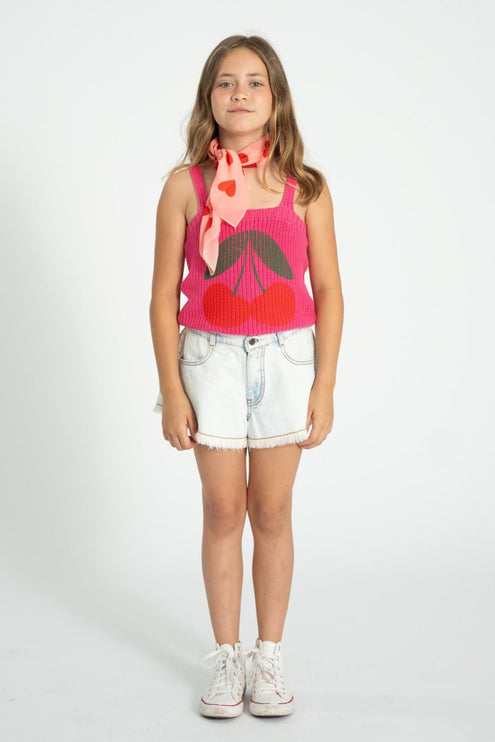 girl wearing pink knitted top pair with denim shorts