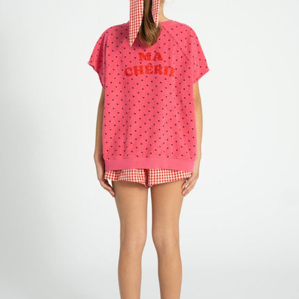 kid wearing pink sweatshirt with mini black hearts print