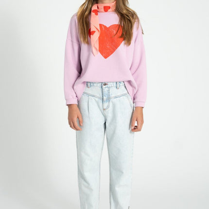 girl wearing lilac sweatshirt with heart printed 