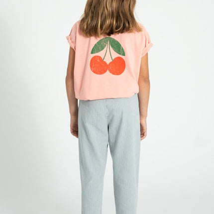girl wearing pink shirt with cherry print at the back