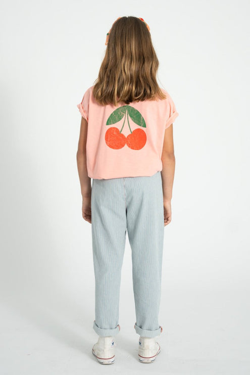 girl wearing pink shirt with cherry print at the back