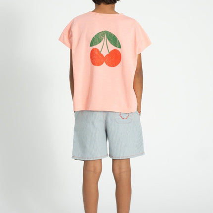 boy wearing shirt with cherry print at tthe back
