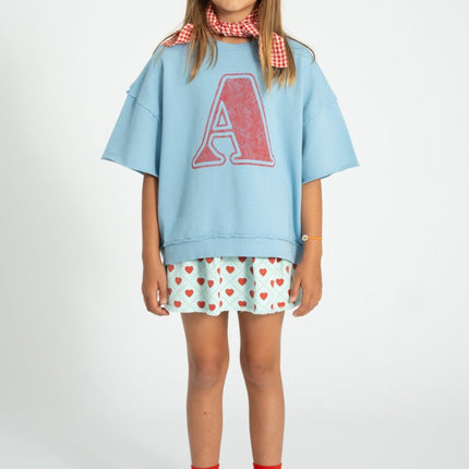 girl wearing shortsleeve sweatshirt with A print 