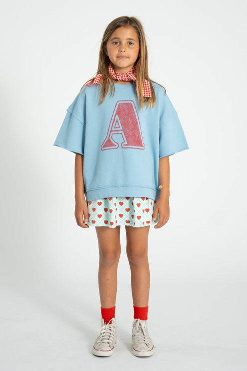 a girl wearing sweatswirt paired with light blue skirt 
