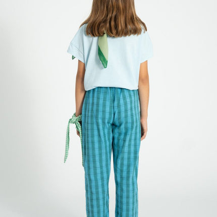 girl wearing green and blue checkered trouser pants 