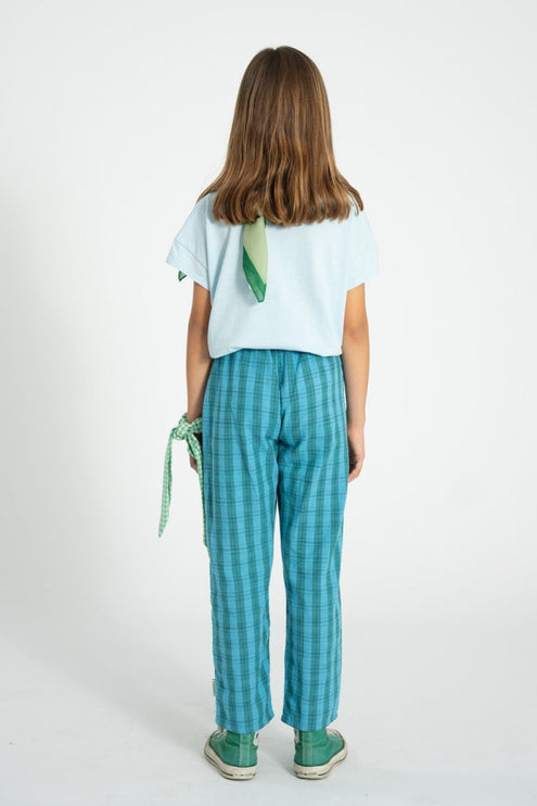girl wearing green and blue checkered trouser pants 