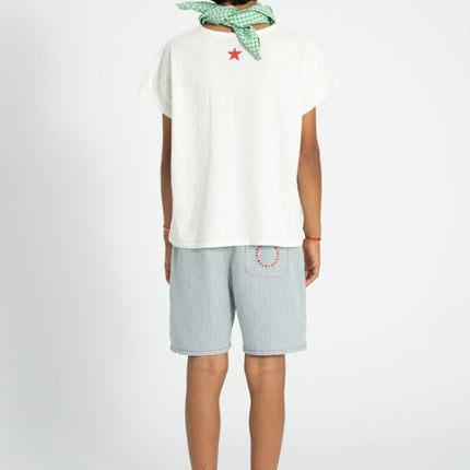 child wearing white shirt with red star on top
