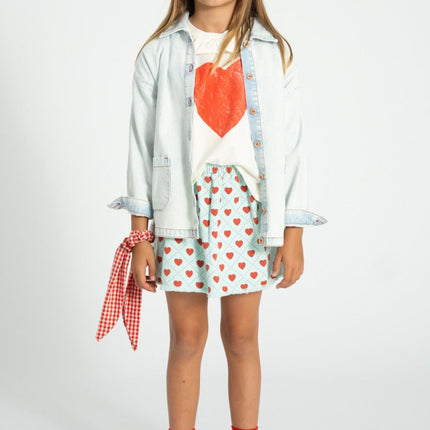 girl wearing denim jacket and white shirt with heart print 