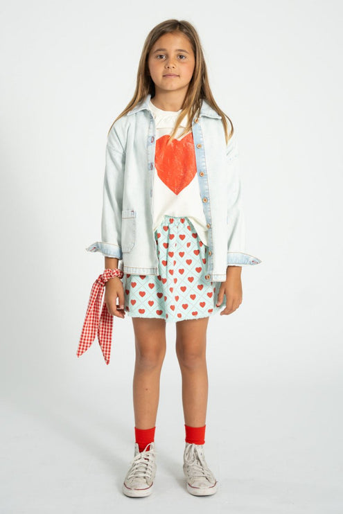girl wearing denim jacket and white shirt with heart print 