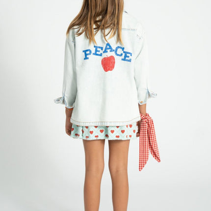 child wearing denim jacket with 'peace' print 