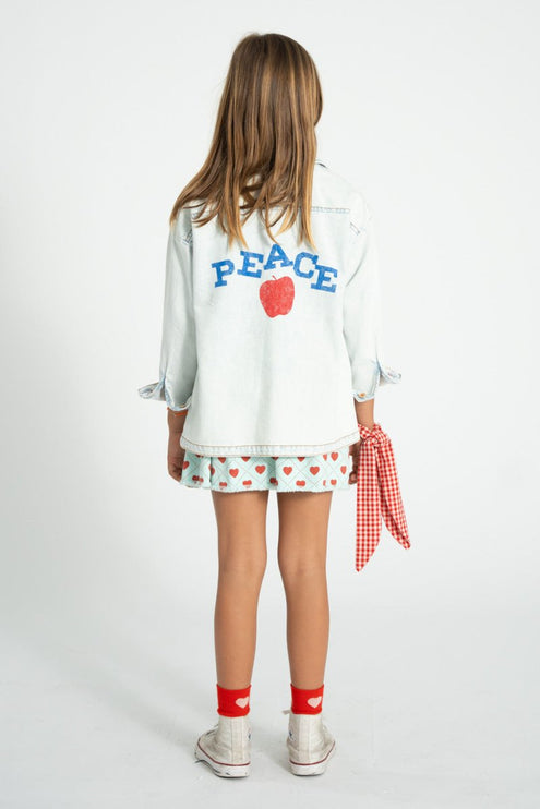 child wearing denim jacket with 'peace' print 