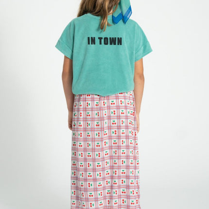 girl wearing tshirt with print at the back paired with long skirt