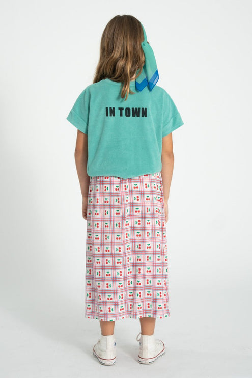 girl wearing tshirt with print at the back paired with long skirt