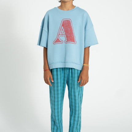 boy wearing blue shortsleeve sweatshirt with A print 