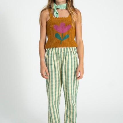 girl wearing knitted top with flower detail