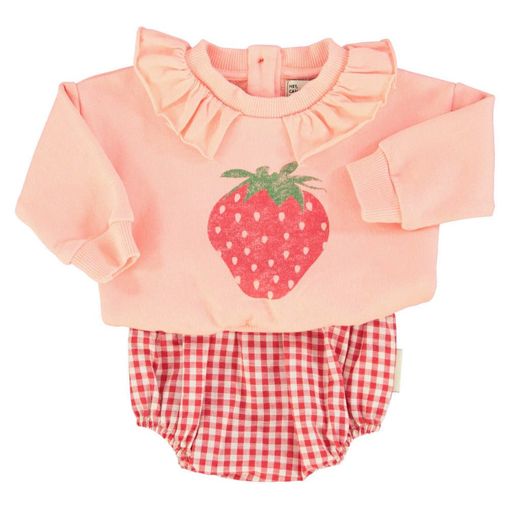 pink baby sweatshirt paired with checkered romper