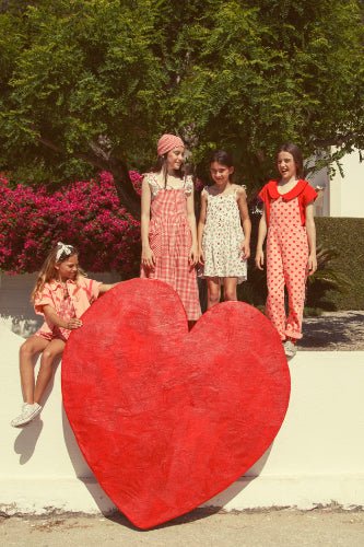 Children in colorful dresses standing around