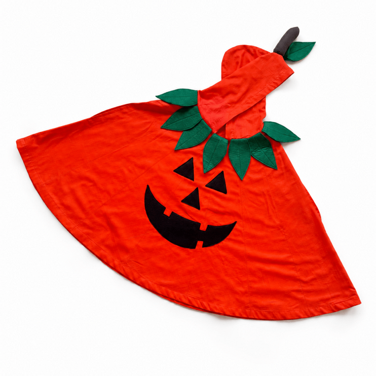 A bright orange pumpkin costume cape with a black jack-o'-lantern face and green felt leaves and stem, laid flat on a white background.