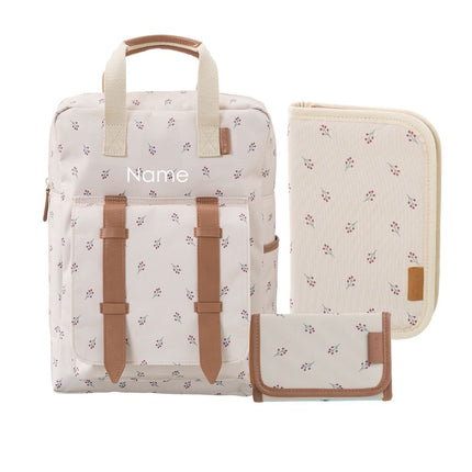 A personalized backpack set with a matching zippered pouch and wallet, featuring a cream and brown floral pattern, tan faux-leather straps, and a customizable name.