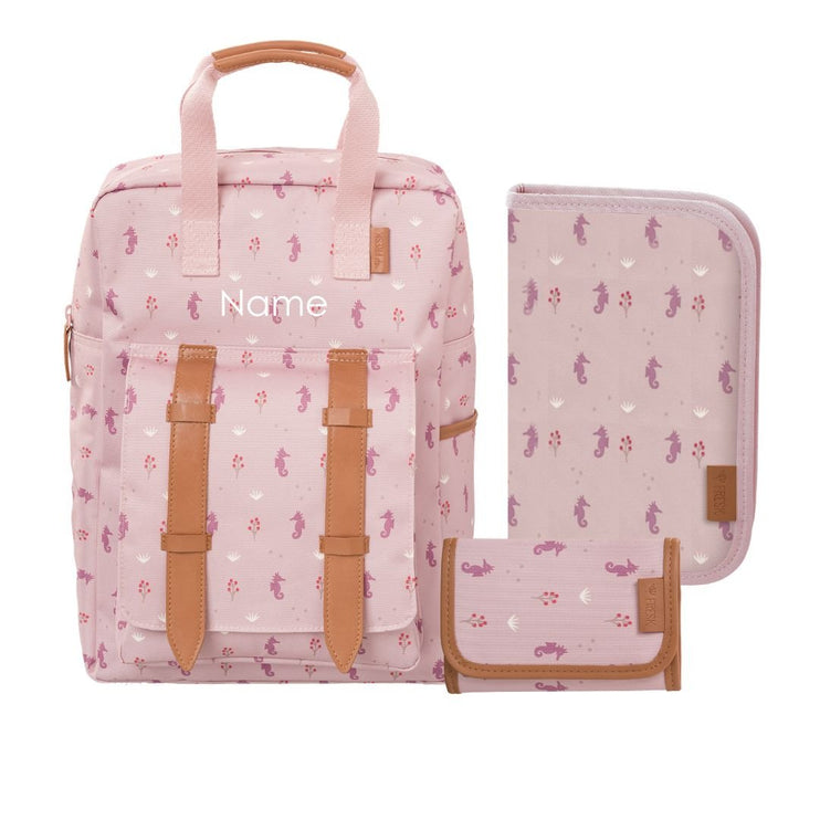 A pink seahorse-patternedincluding a backpack with tan faux-leather straps, a matching zippered pouch, and a folded wallet. The backpack can be personalized.