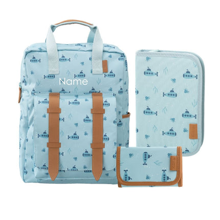 A light blue fabric travel set with a repeating submarine pattern, featuring a backpack with tan faux-leather straps, a matching zippered pouch, and a small wallet . Backpack can be personalized