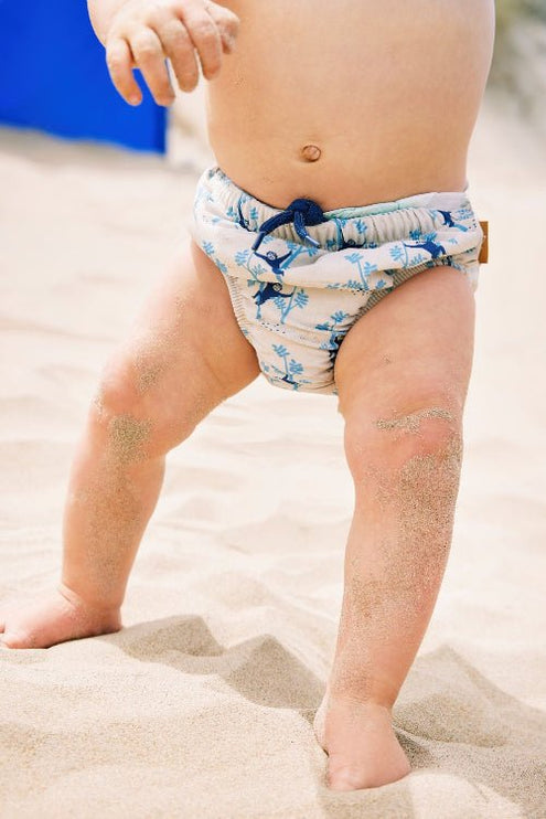 Baby boy wearing Cream with blue Monkey prints reusabe swim diaper pants