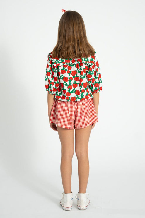 a blouse with red roses print 