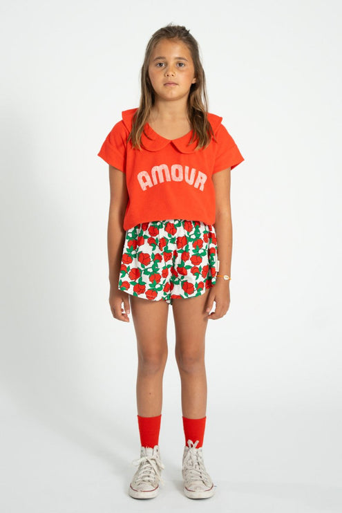 kid wearing shorts with red rose pattern 