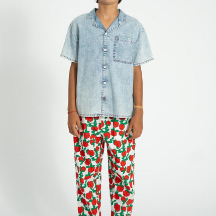 boy wearing relaxed pants with red rose pattern