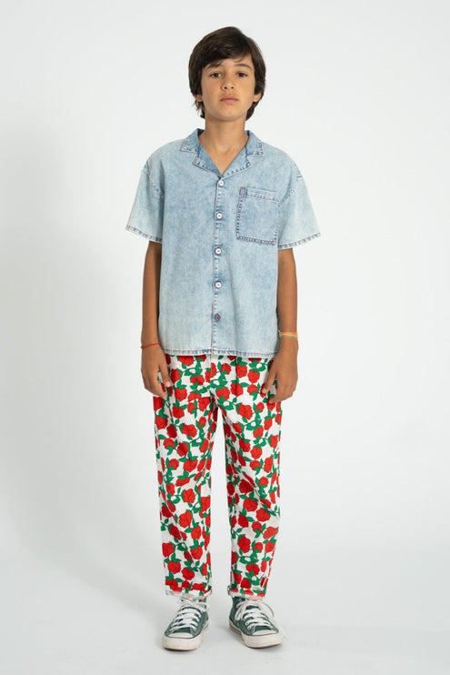 boy wearing relaxed pants with red rose pattern