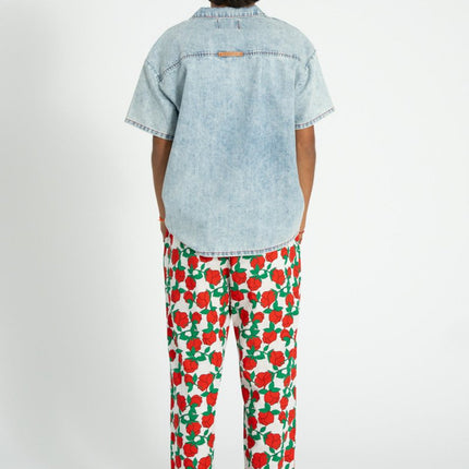 kid wearing pants with red rose pattern