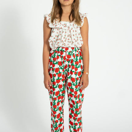 girl wearing floral top with red rose pattern pants 