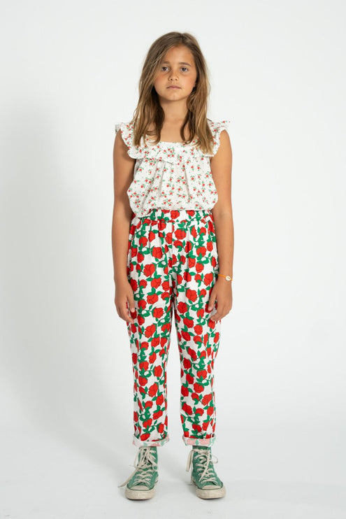 girl wearing floral top with red rose pattern pants 