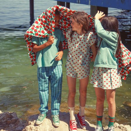 Girl wearing light blue short skirt with red hearts all over