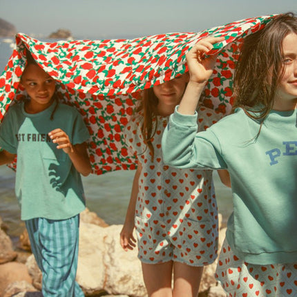 Girl wearing light blue short skirt with red hearts all over