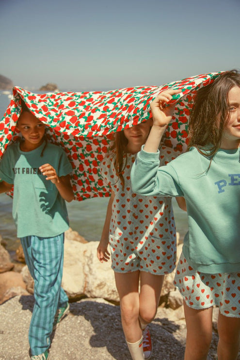 Girl wearing light blue short skirt with red hearts all over